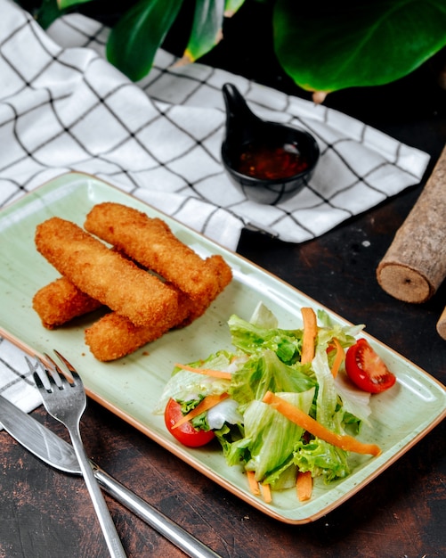 Chicken nuggets with vegetables on the table