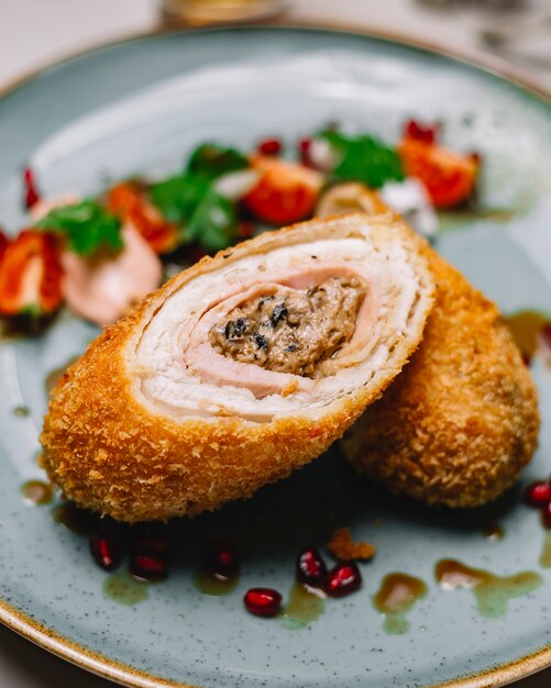 Chicken roll fried in crackers with mushroom cream onion inside side view