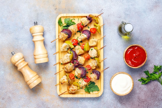 Chicken shish kebab with vegetables,ketchup,mayonnaise,top view