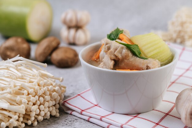 Chicken soup with corn, shiitake mushroom, enoki mushroom, and carrot.