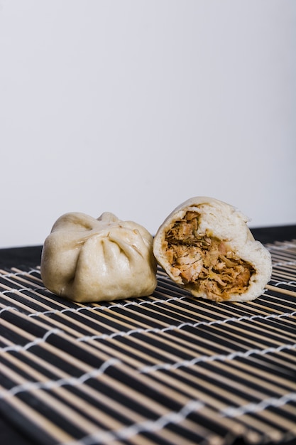 Free Photo chicken stuffed dumpling on placemat against white backdrop