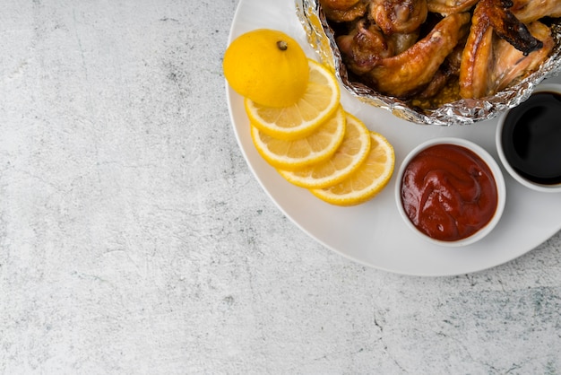 Free photo chicken wings with ketchup on grey table