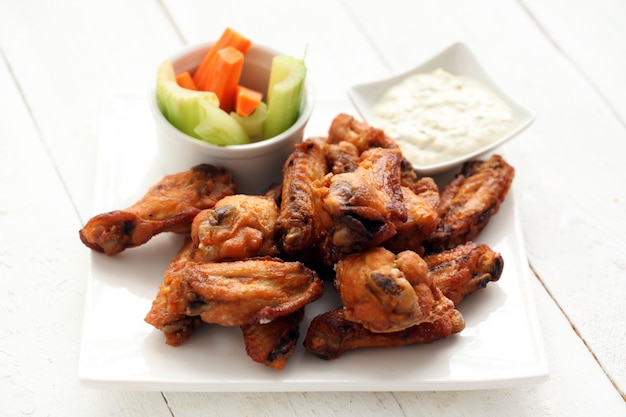 Chicken wings with sauce and vegetables 