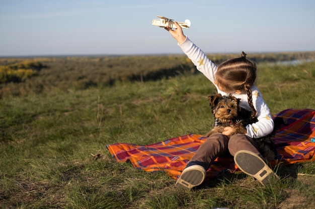 Child and dog playing outdoors