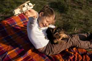 Free photo child and dog playing outside high view