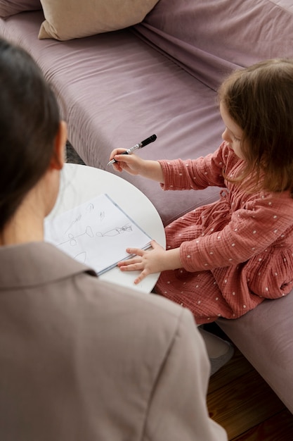 Child doing therapy session with psychologist