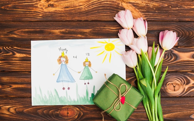 Free photo child drawing of queen and princess with flowers and gift box