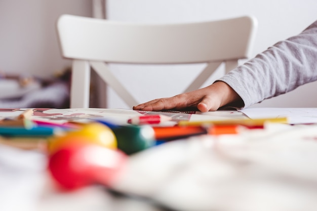 Child drawing with colorful pencils