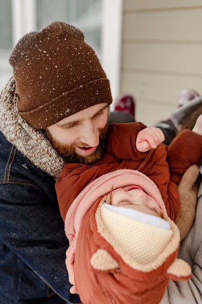 Child enjoying winter activities with their family