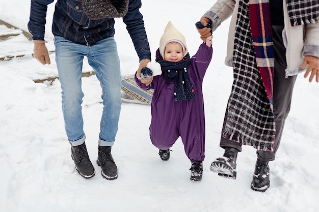 Child enjoying winter activities with their family