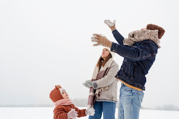 Child enjoying winter activities with their family