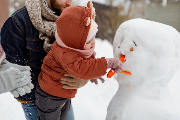 Free Photo child enjoying winter activities with their family