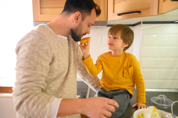 Child giving his father half of orange