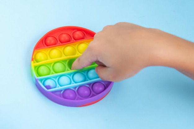 Child hand playing with pop it toy