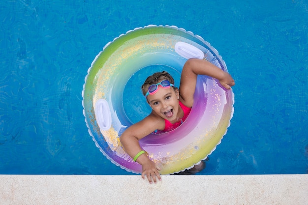 Child having fun with floater at the pool