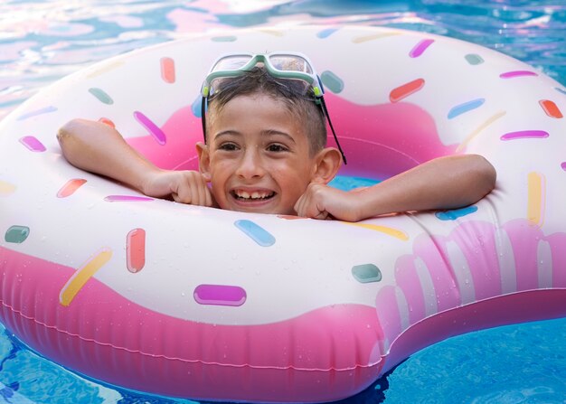 Child having fun with floater at the pool