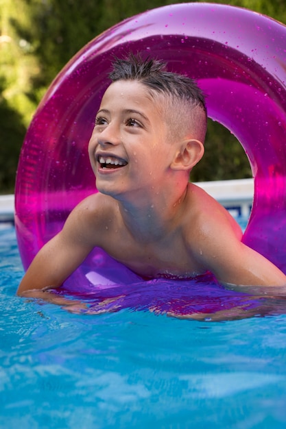 Child having fun with floater at the pool