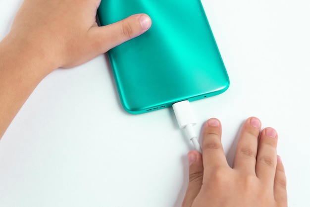 Child holding cellphone over white background