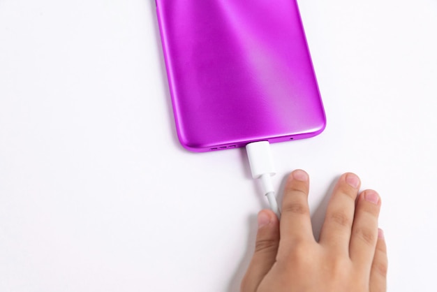 Free photo child holding cellphone over white background