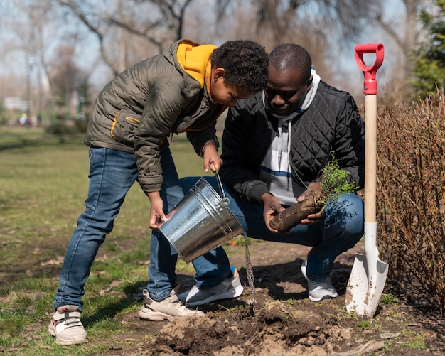 Child learning how to plant a tree