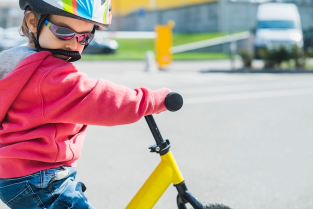 Free photo child riding bike outside