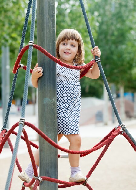 child on ropes at playground