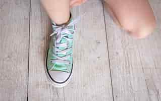 Free photo child successfully ties shoes close up on feet