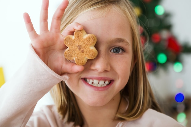 Free Photo child with a cookie in the eye