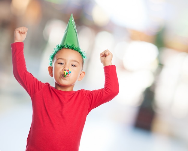 Child with a party hat celebrating