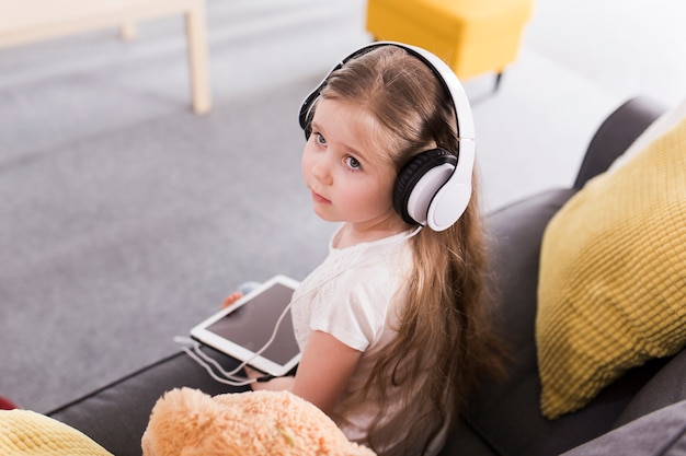 Child with tablet and headphones