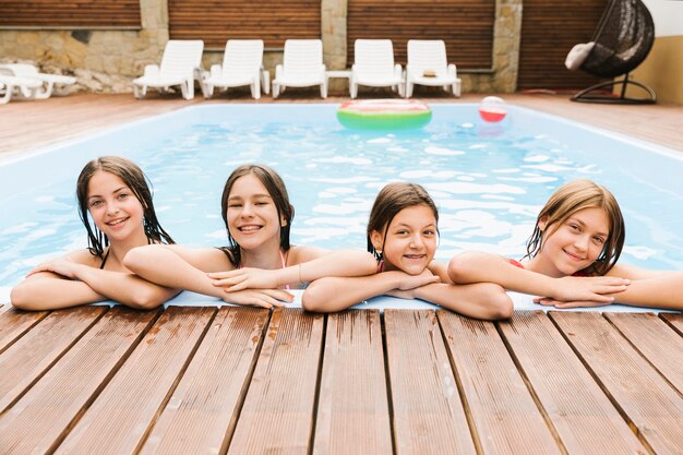 Children being happy in swimming pool