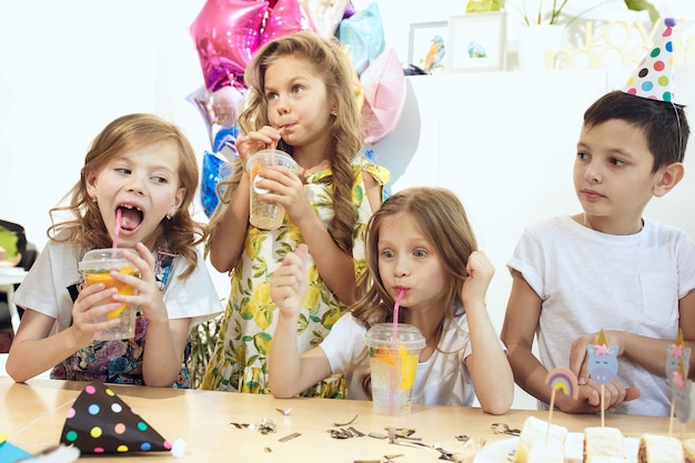 The children and birthday decorations.