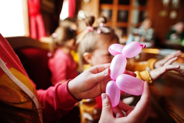 Children at birthday party make balloons animals