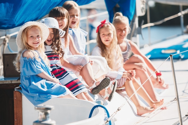 children on board of sea yacht. teen or child girls outdoor.