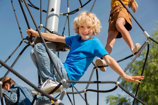 Children climbing rope together close up