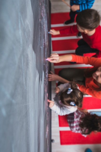 Free Photo children drawing on blackboard