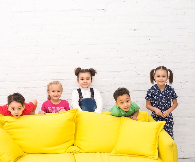 Free Photo children group playing in a sofa