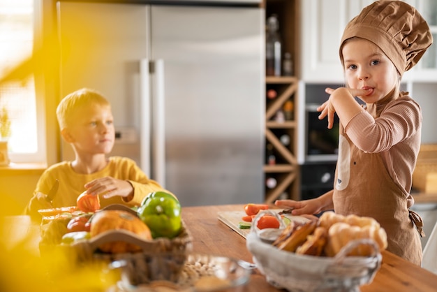 Free photo children having fun cooking in the kitchen at home