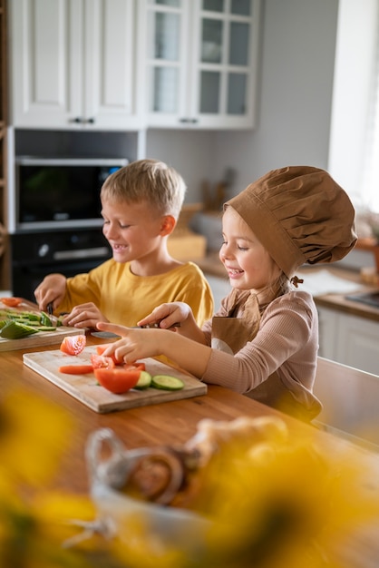 Free photo children having fun cooking in the kitchen at home