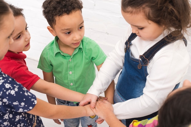 Children holding hand in group