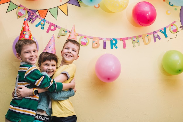 Free Photo children hugging on birthday party