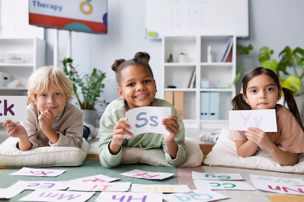 Free photo children learning together how to speak in therapy