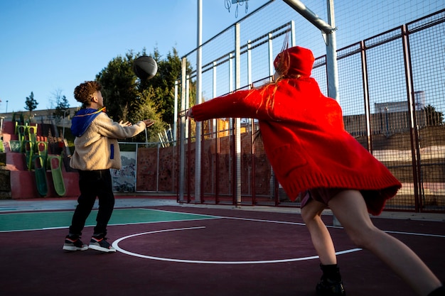 Children playing basketball together outside