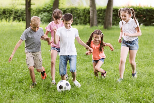 Free photo children playing football outside