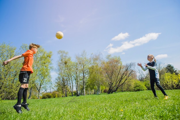 Children playing soccer in the park