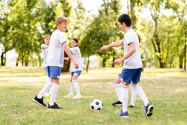 Children playing together football