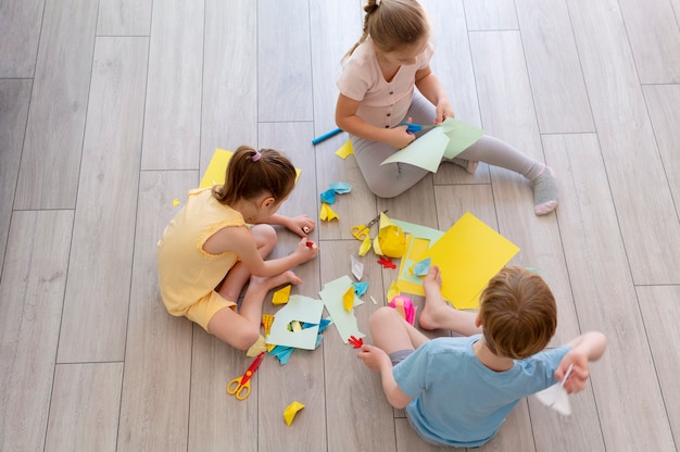 Children playing with paper full shot