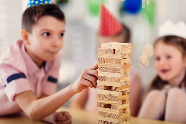 Free photo children playing wooden game