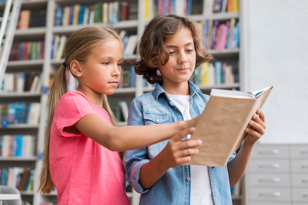 Children reading a book together