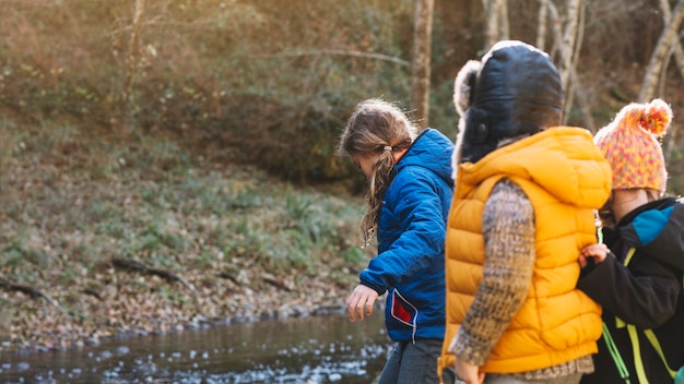 Free photo children at river in forest